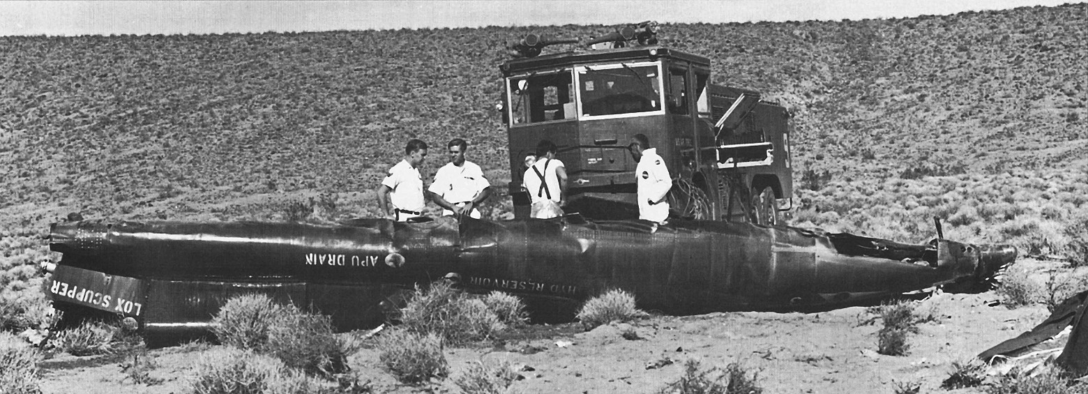 A fire truck is parked near the remains of the X-15 no. 3 forward fuselage on 15 November 1967.