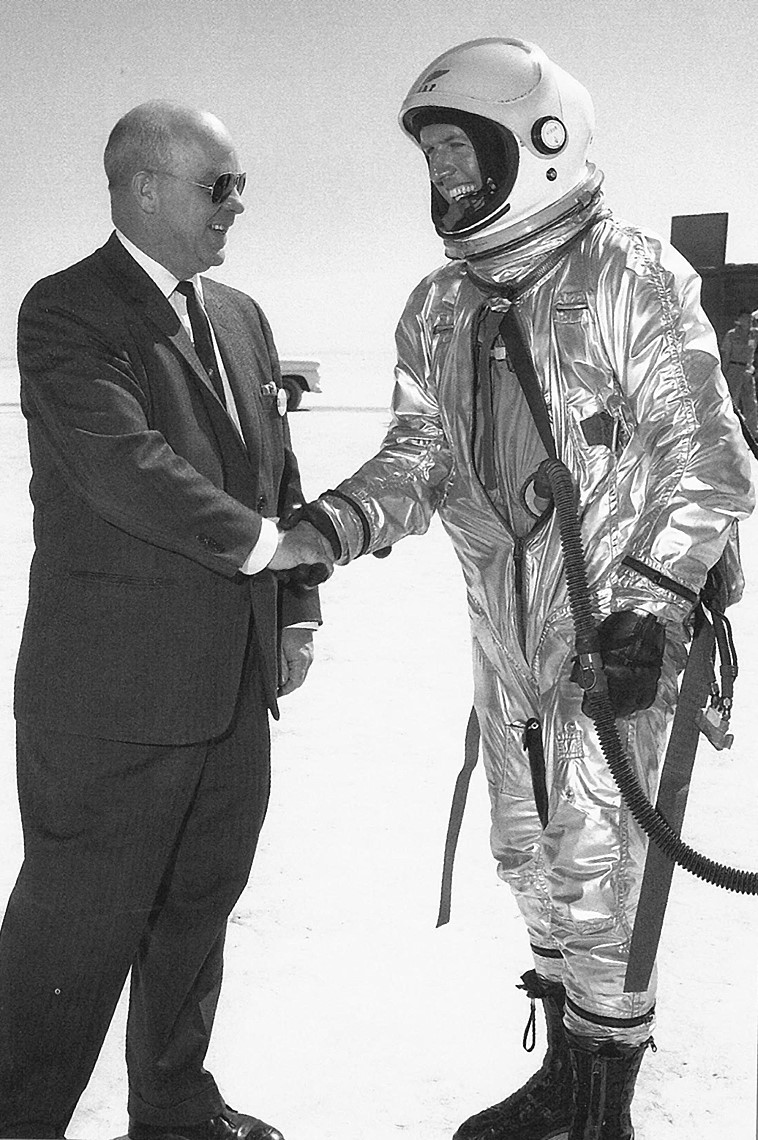 Joe Walker is greeted by Paul Bikle, the director of the X-15 program, after his record altitude flight on 22 August 1963. This was Walker's third and final astronaut qualification flight in the X-15, and was also his last flight in the program.